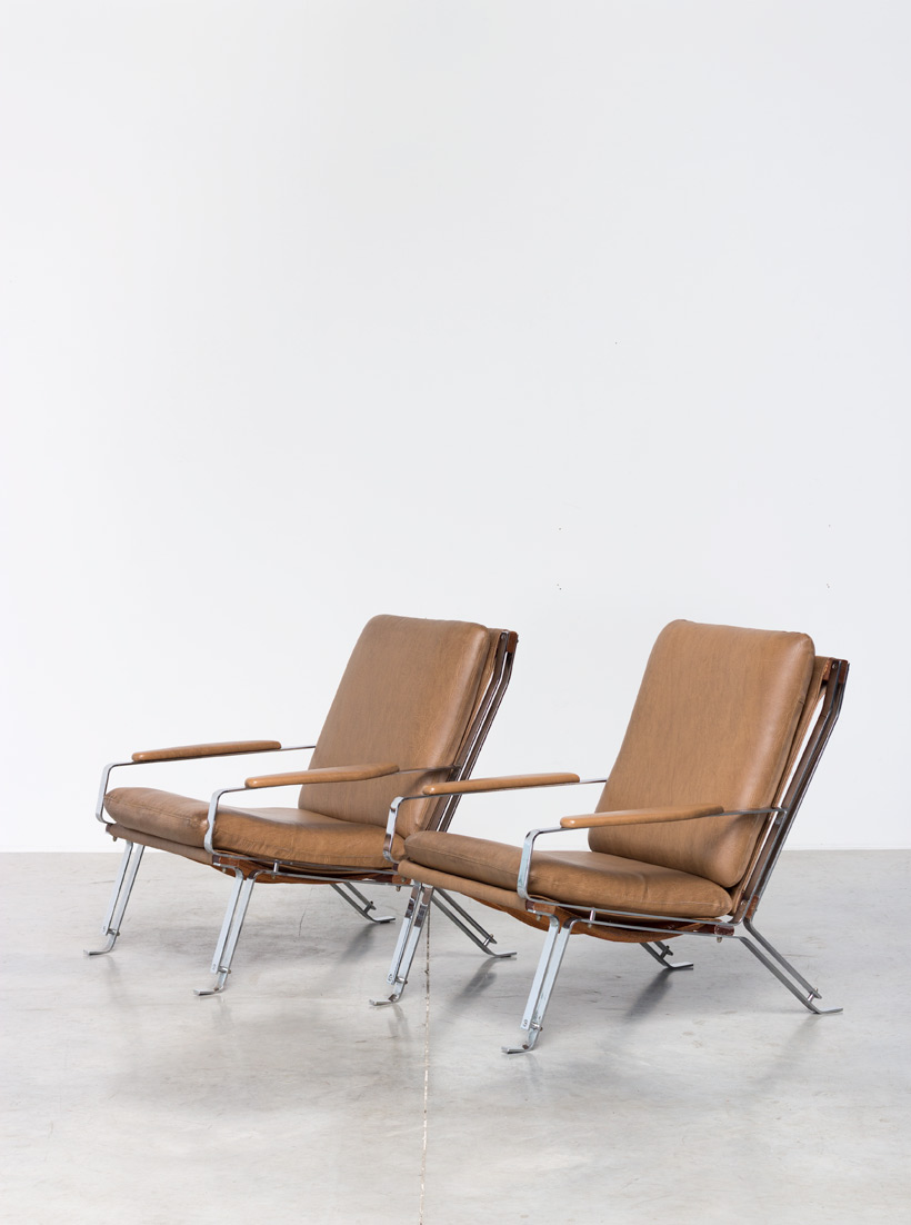 Pair sculptural chromed lounge chairs with armrests